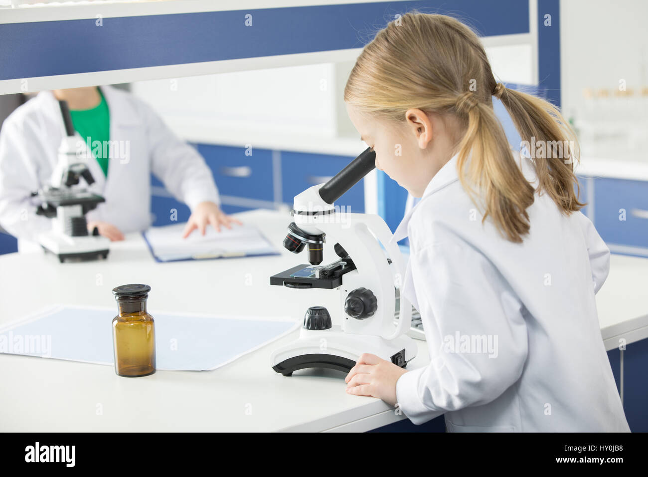 Schoolgirl in lab coat hi-res stock photography and images - Alamy
