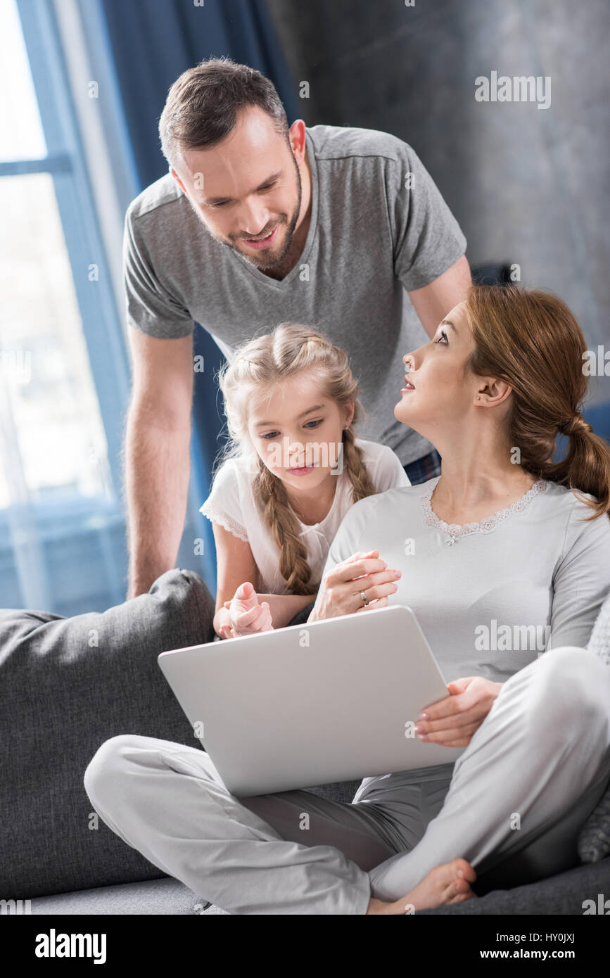 Young family using laptop together at home Stock Photo - Alamy