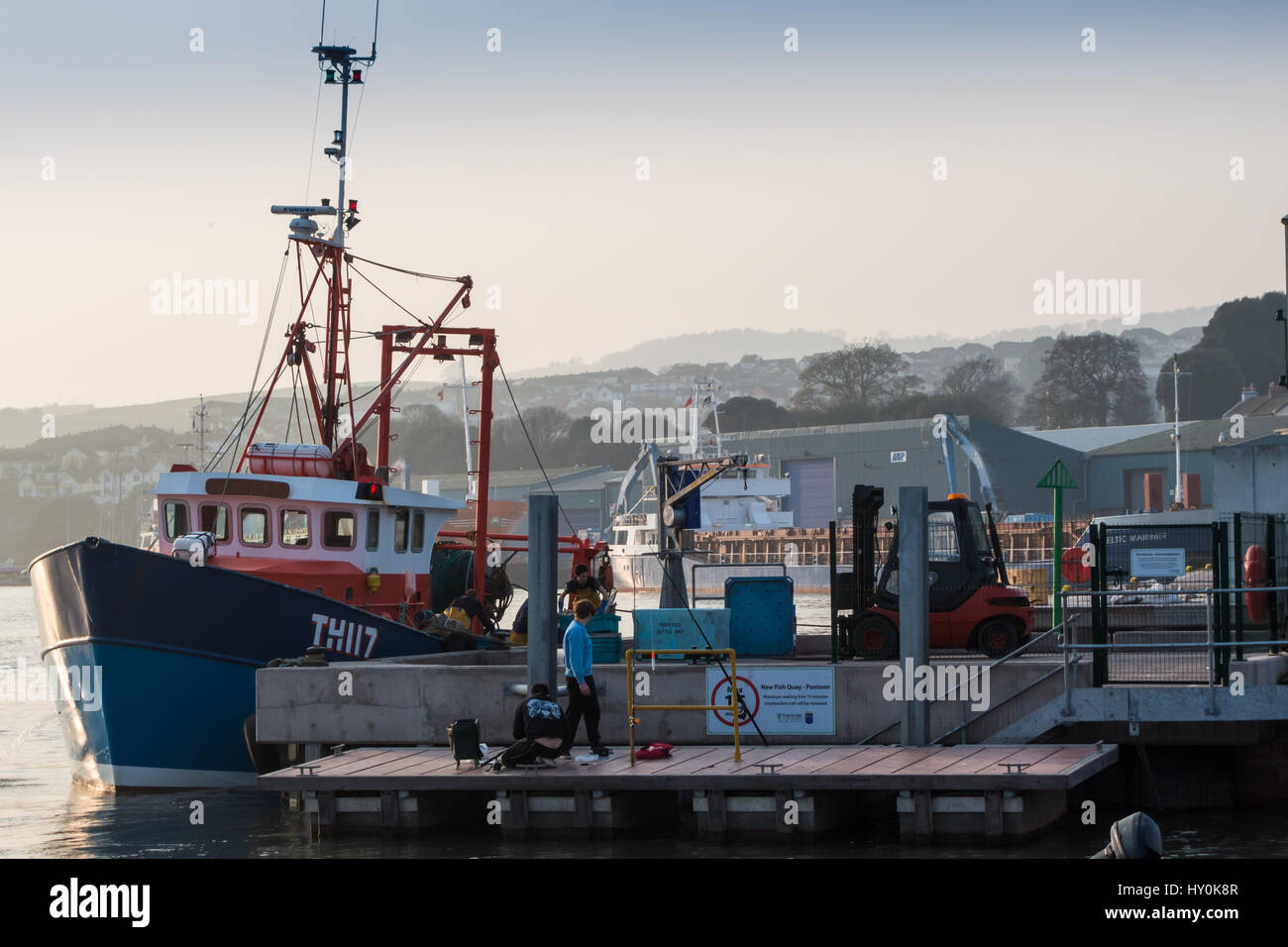 A Teignmouth trawler, docking to unload its catch of fish on the fish