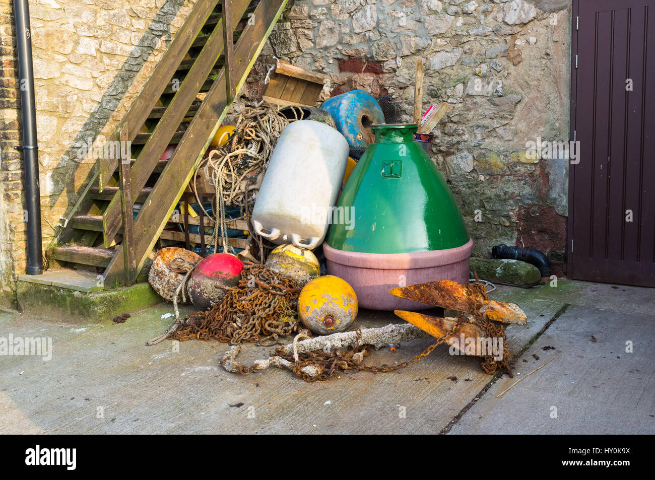 Collection of maritime objects, anchors,buoys, on a quay, Teignmouth, UK. Stock Photo