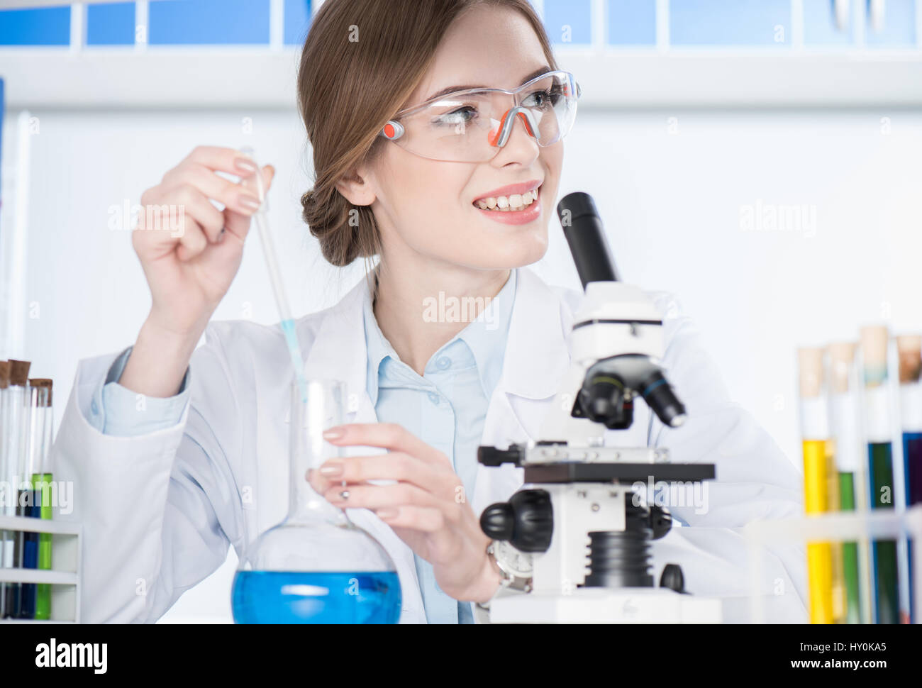 Young female scientist making chemical experiment in laboratory Stock Photo