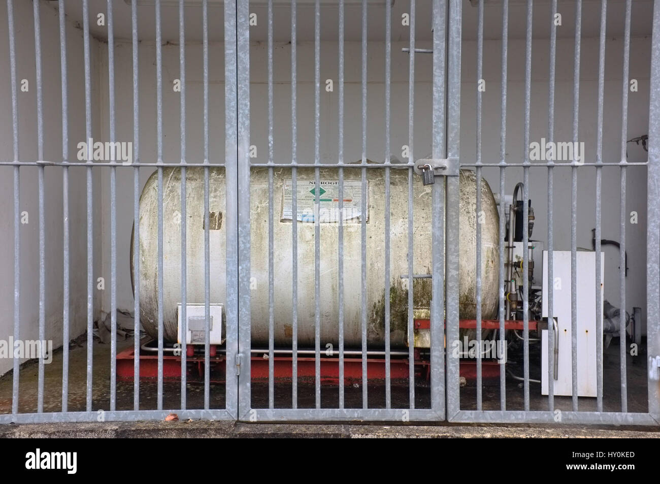 A Nitrogen cylinder behind safety bars. Stock Photo