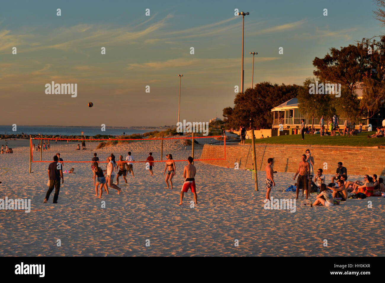 The summer sun sets over Volley Ball players on City Beach, Western Australia. Stock Photo