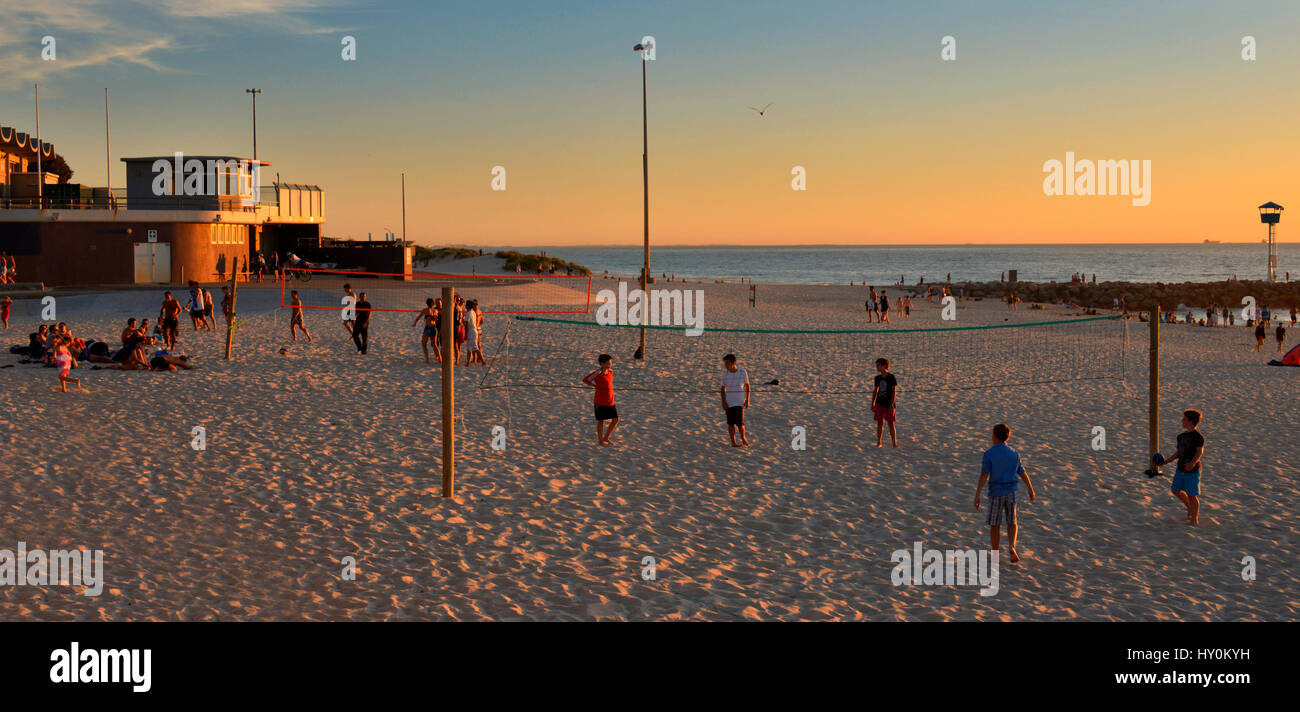 The summer sun sets over Volley Ball players on City Beach, Western Australia. Stock Photo