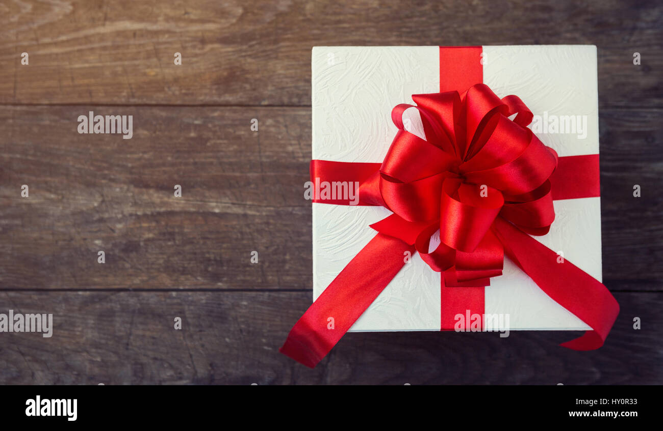 White gift box with red ribbon and bow background, top view Stock Photo ...