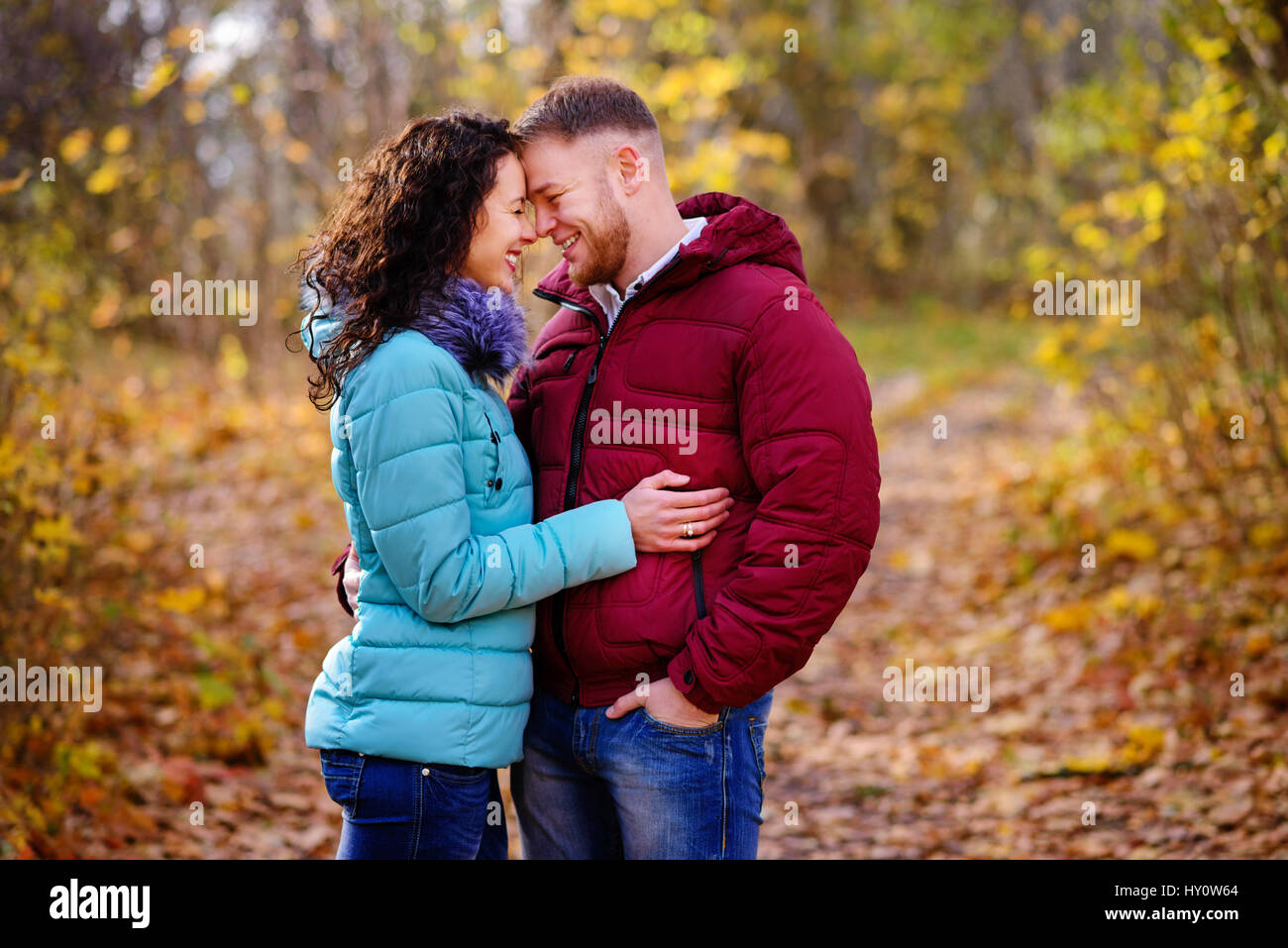Lovers walking hand in hand in autumn park Stock Photo - Alamy