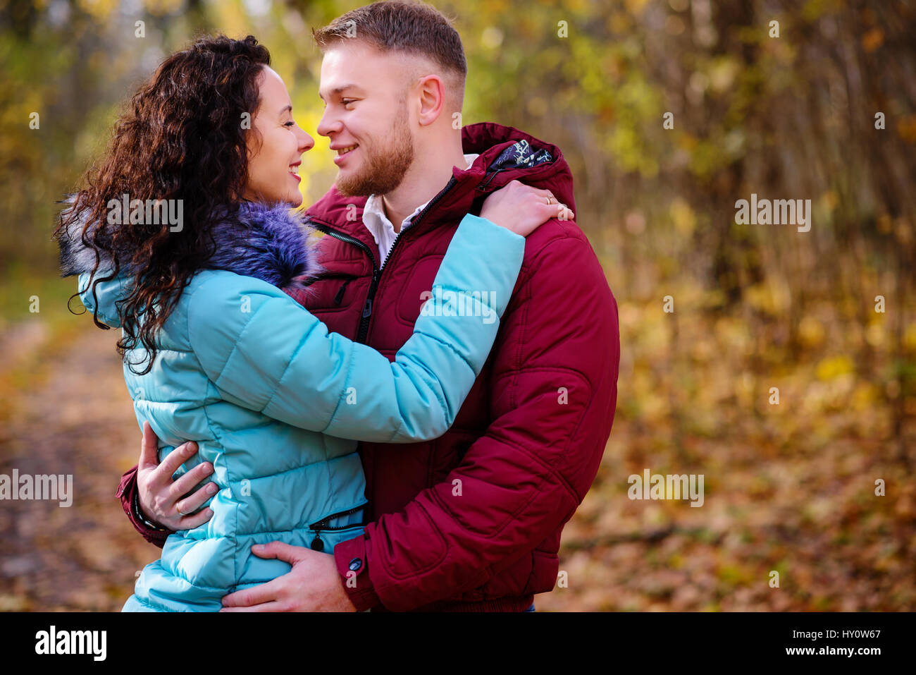 Portrait of young loving couple kissing in autumn park Stock Photo - Alamy