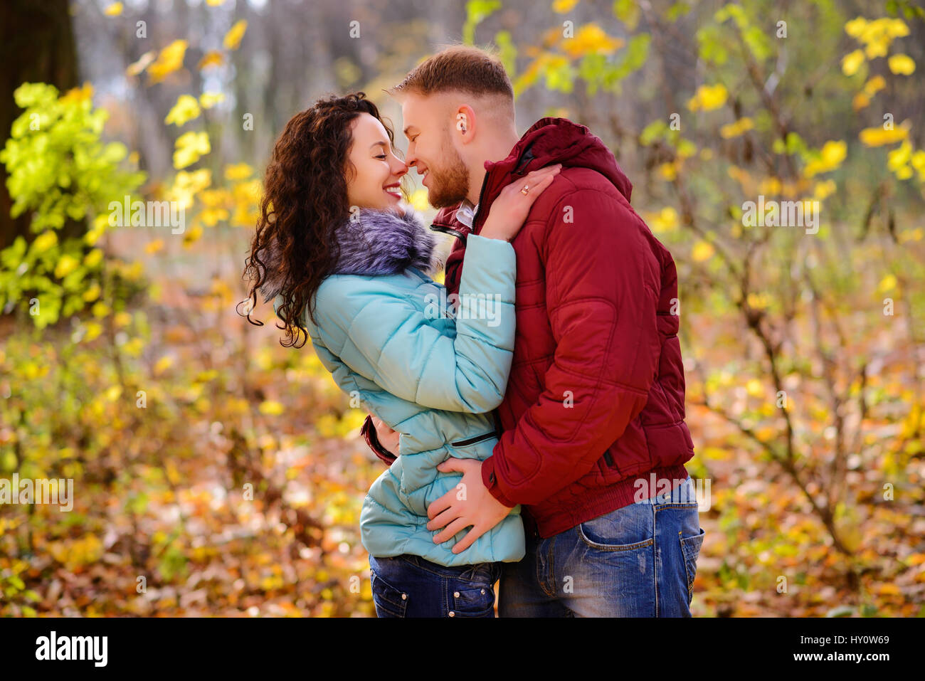 Portrait of young loving couple kissing in autumn park Stock Photo - Alamy