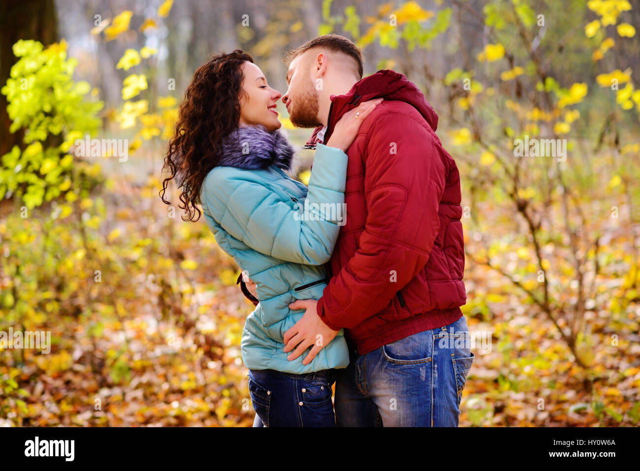 Portrait of young loving couple kissing in autumn park Stock Photo - Alamy