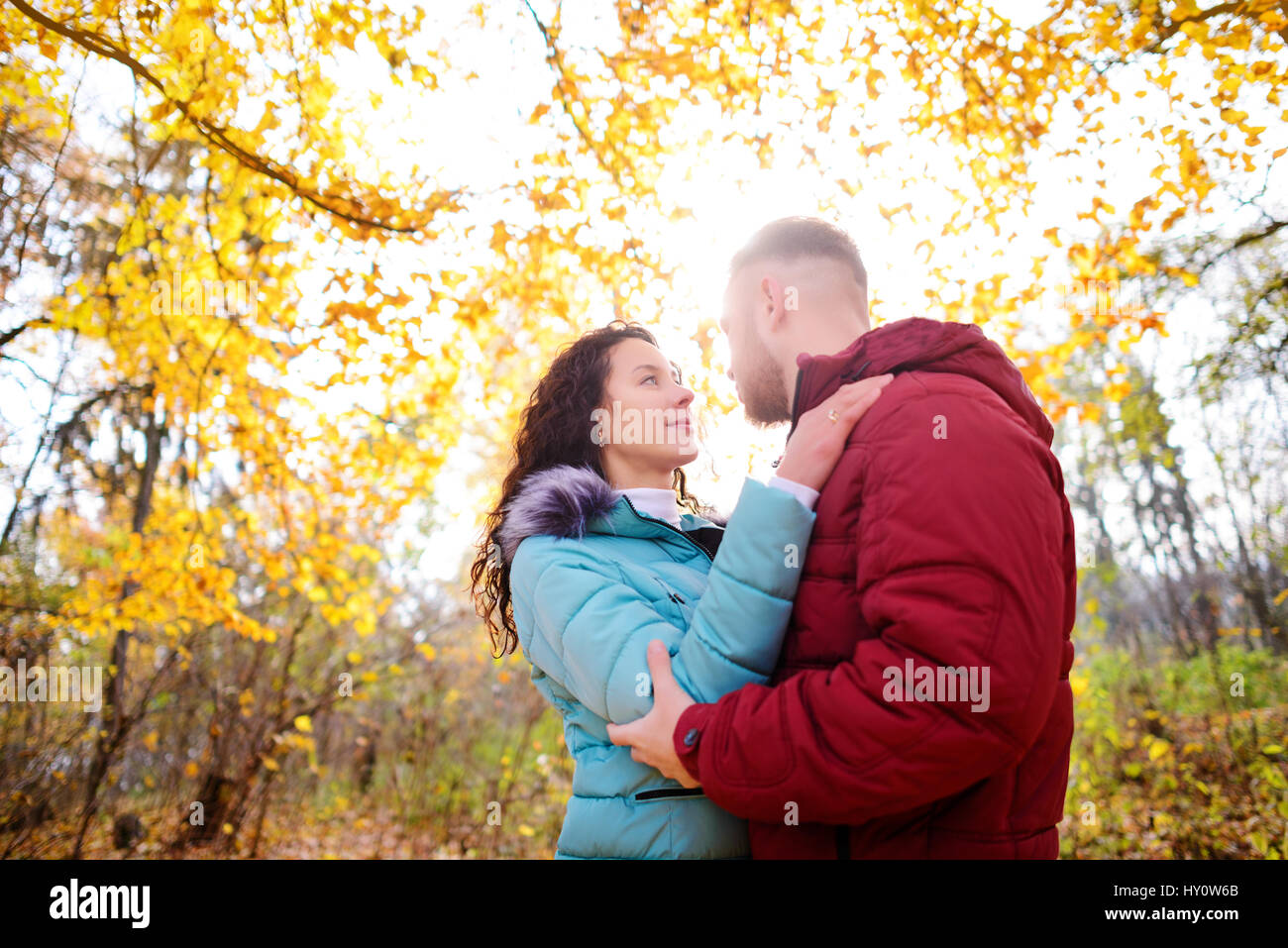 Portrait of young loving couple kissing in autumn park Stock Photo - Alamy