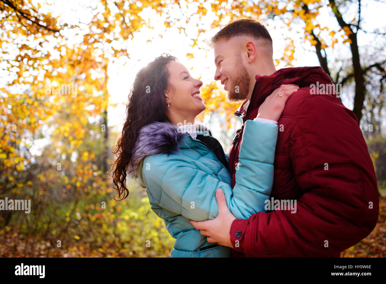 Portrait of young loving couple kissing in autumn park Stock Photo - Alamy