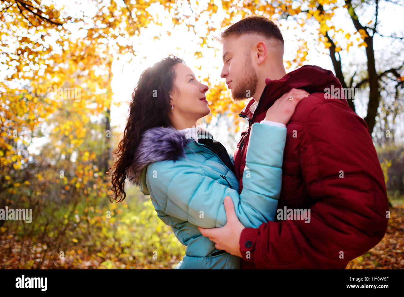 Portrait of young loving couple kissing in autumn park Stock Photo - Alamy