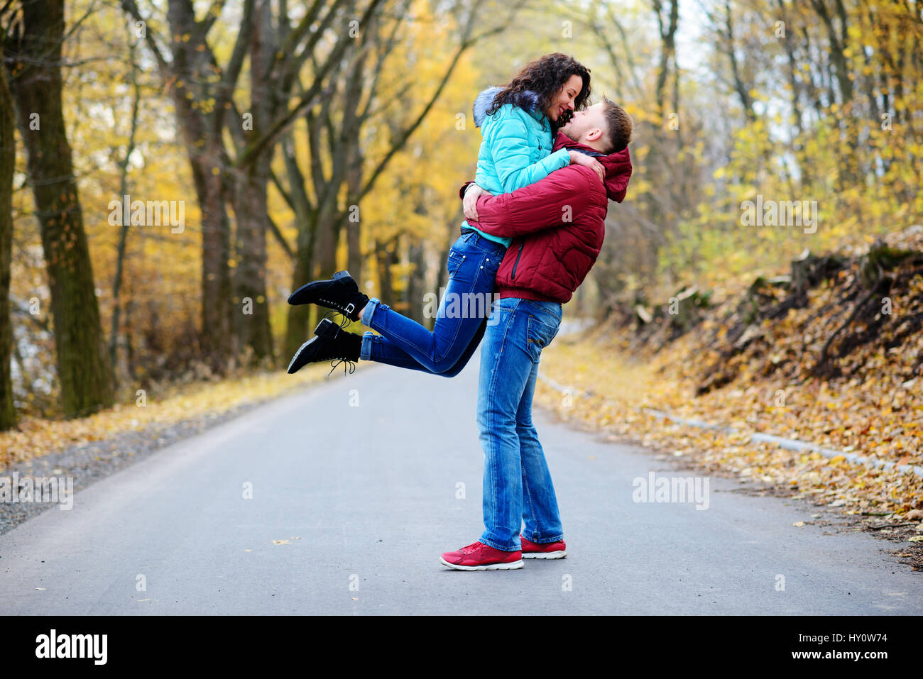 Portrait of young loving couple kissing in autumn park Stock Photo - Alamy