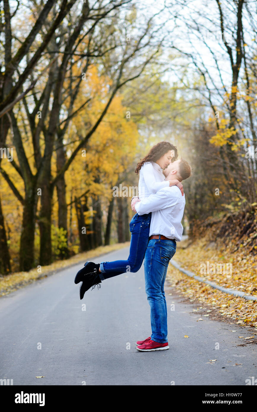 Portrait of young loving couple kissing in autumn park Stock Photo - Alamy