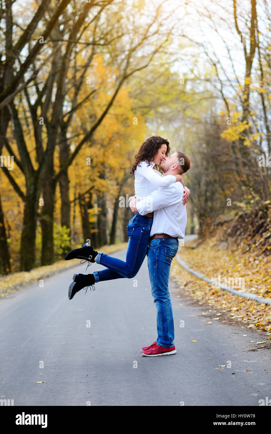 Portrait of young loving couple kissing in autumn park Stock Photo - Alamy
