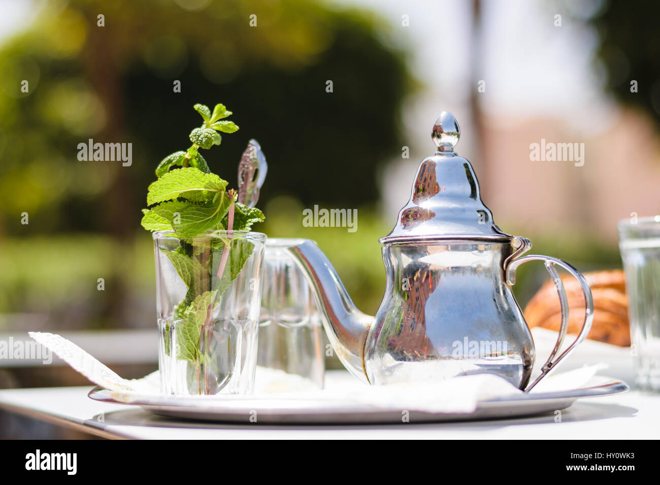 Teapot and glass with mint leaves, Morocco Stock Photo