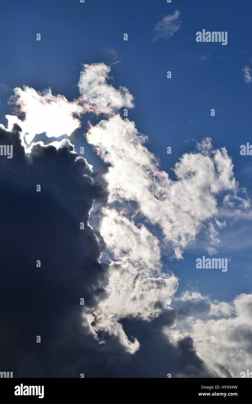 Sun Shining Behind Clouds Stock Photo