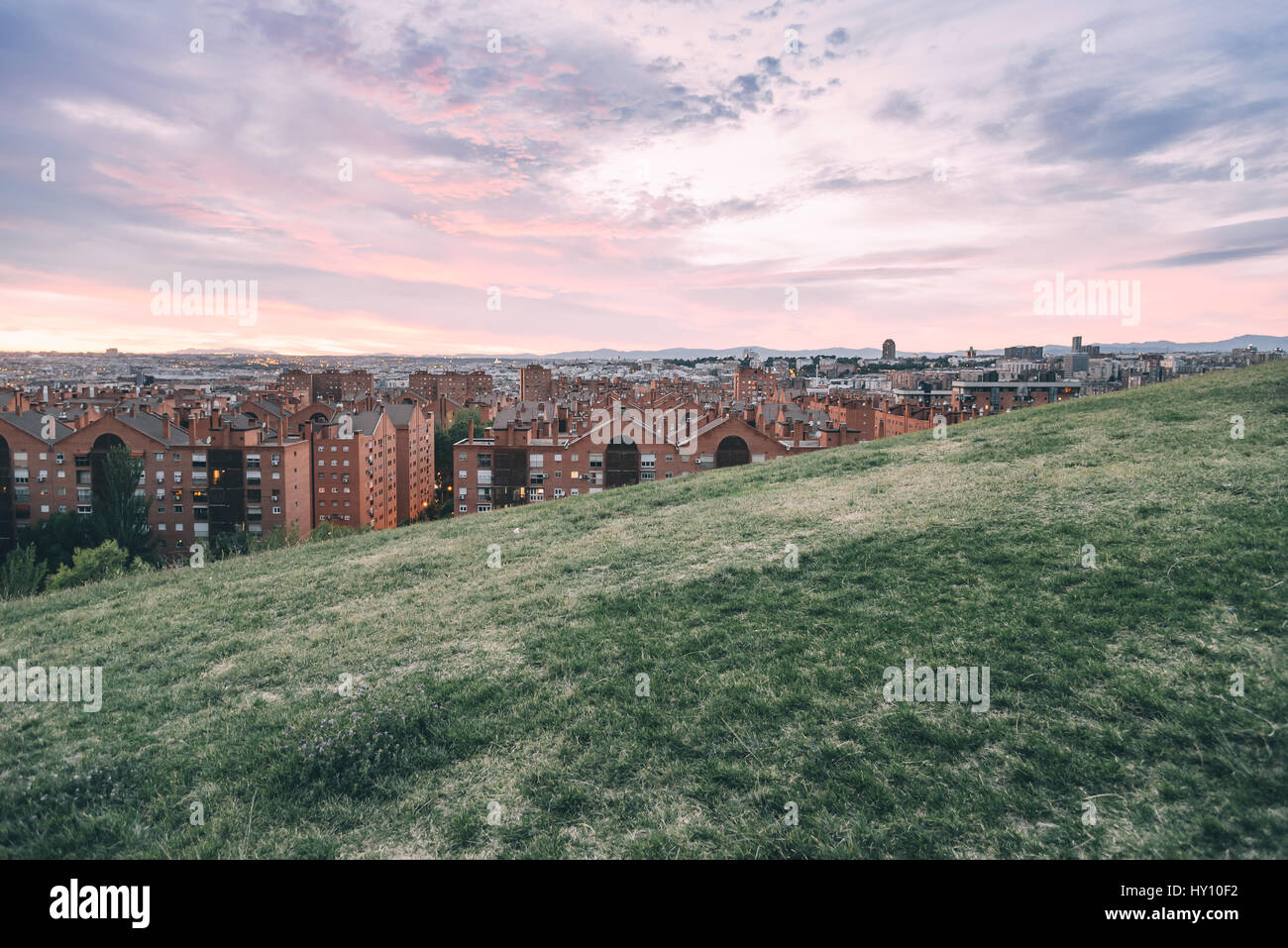 Madrid cityscape at dusk from a residential district and mountain range at background Stock Photo