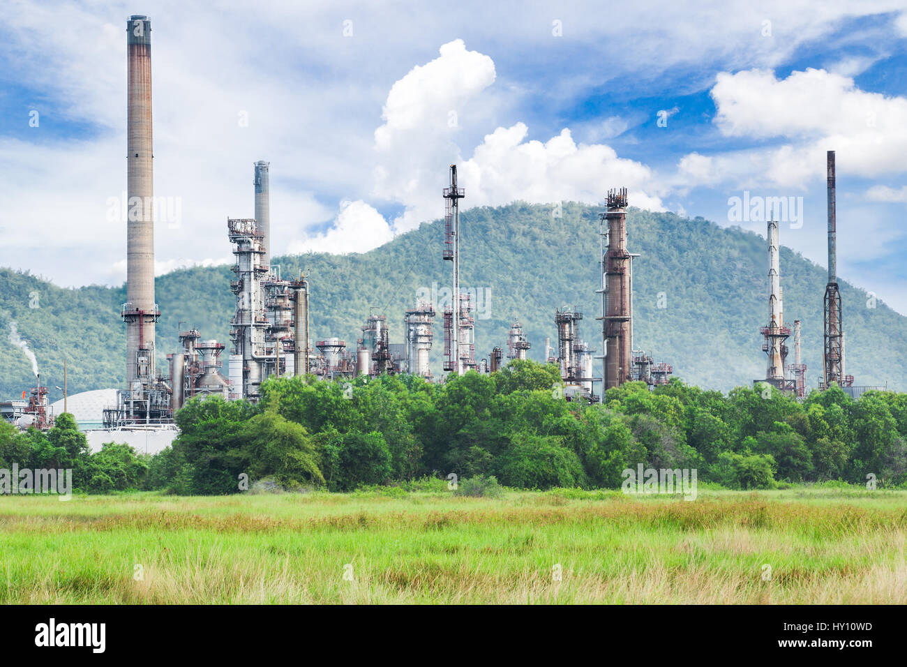 Oil refinery with green field Stock Photo - Alamy
