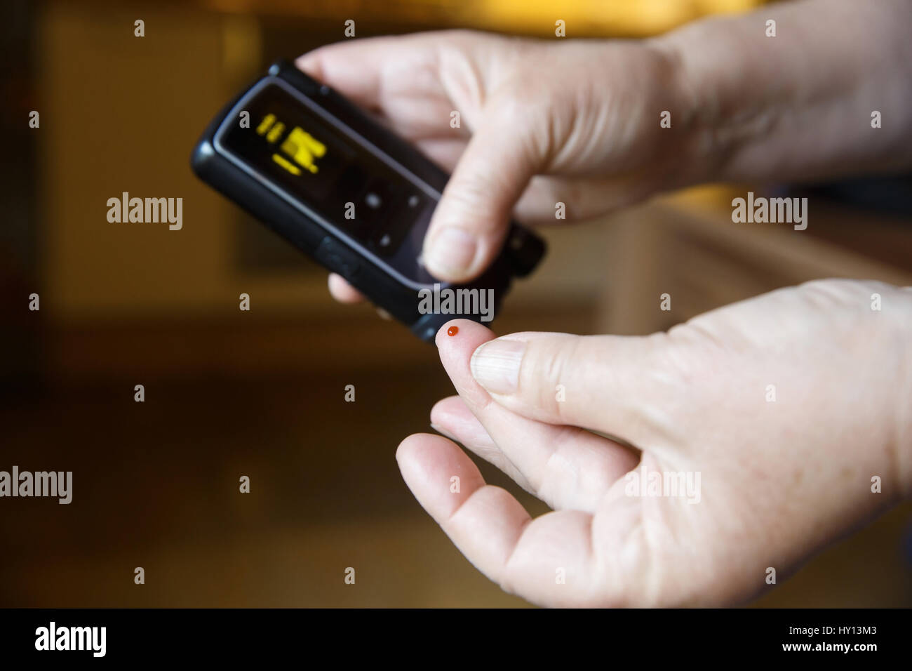 Diabetic patient testing her blood for sugar level at home. Medical process, self-diagnose, common metabolic, widespread and modern epidemic disease c Stock Photo