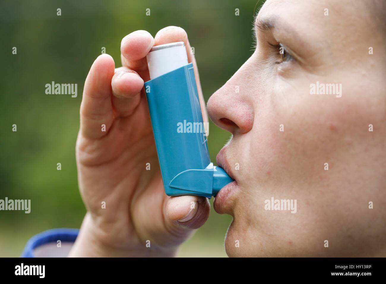 Asthma patient inhaling medication for treating shortness of breath and wheezing. Chronic disease control, allergy induced asthma remedy and chronic p Stock Photo