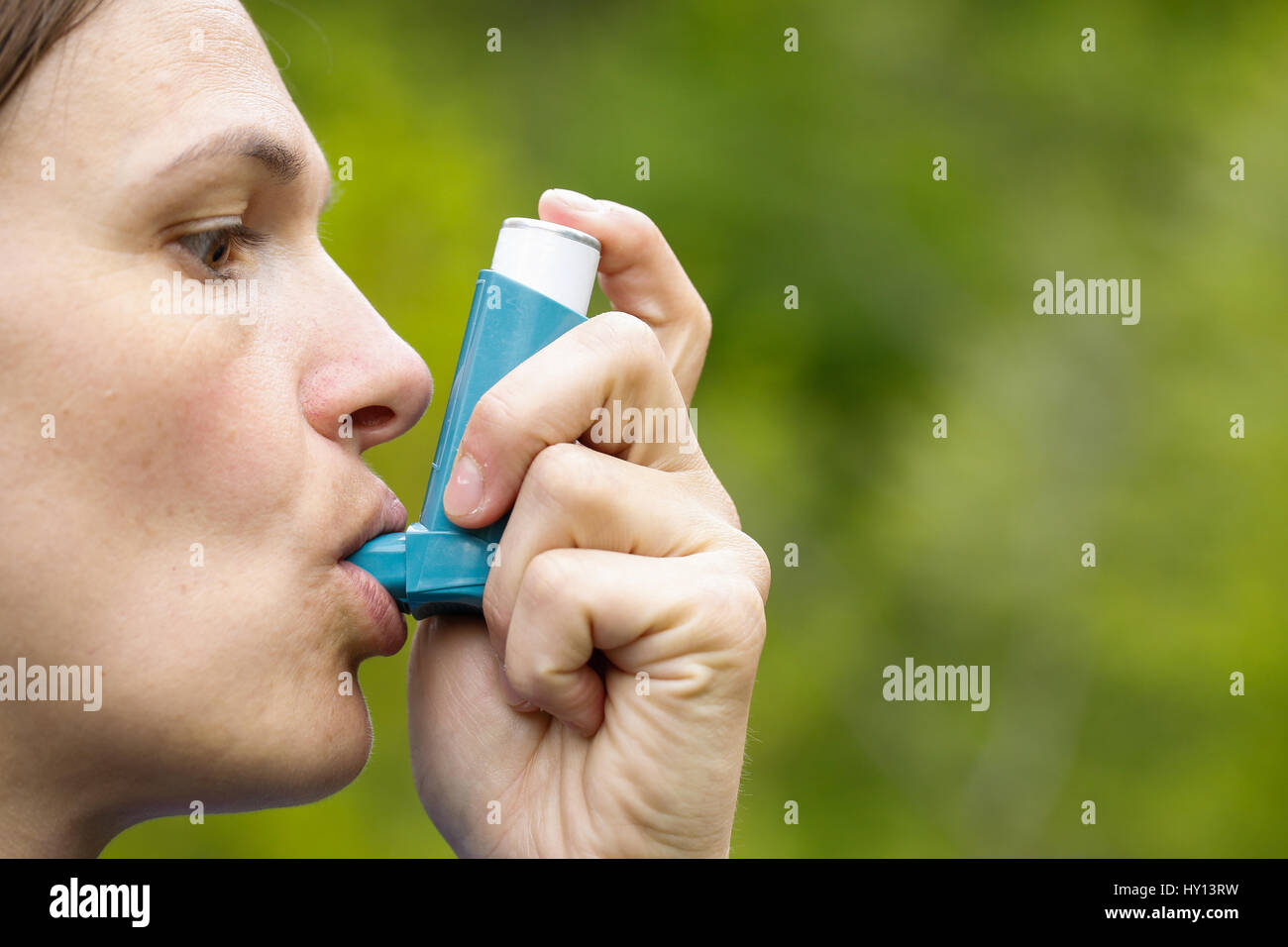 Asthma patient inhaling medication for treating shortness of breath and wheezing. Chronic disease control, allergy induced asthma remedy and chronic p Stock Photo
