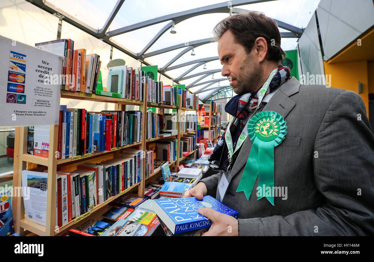 A party delegate buys books at the Green Party Spring Conference at the ACC in Liverpool. Stock Photo