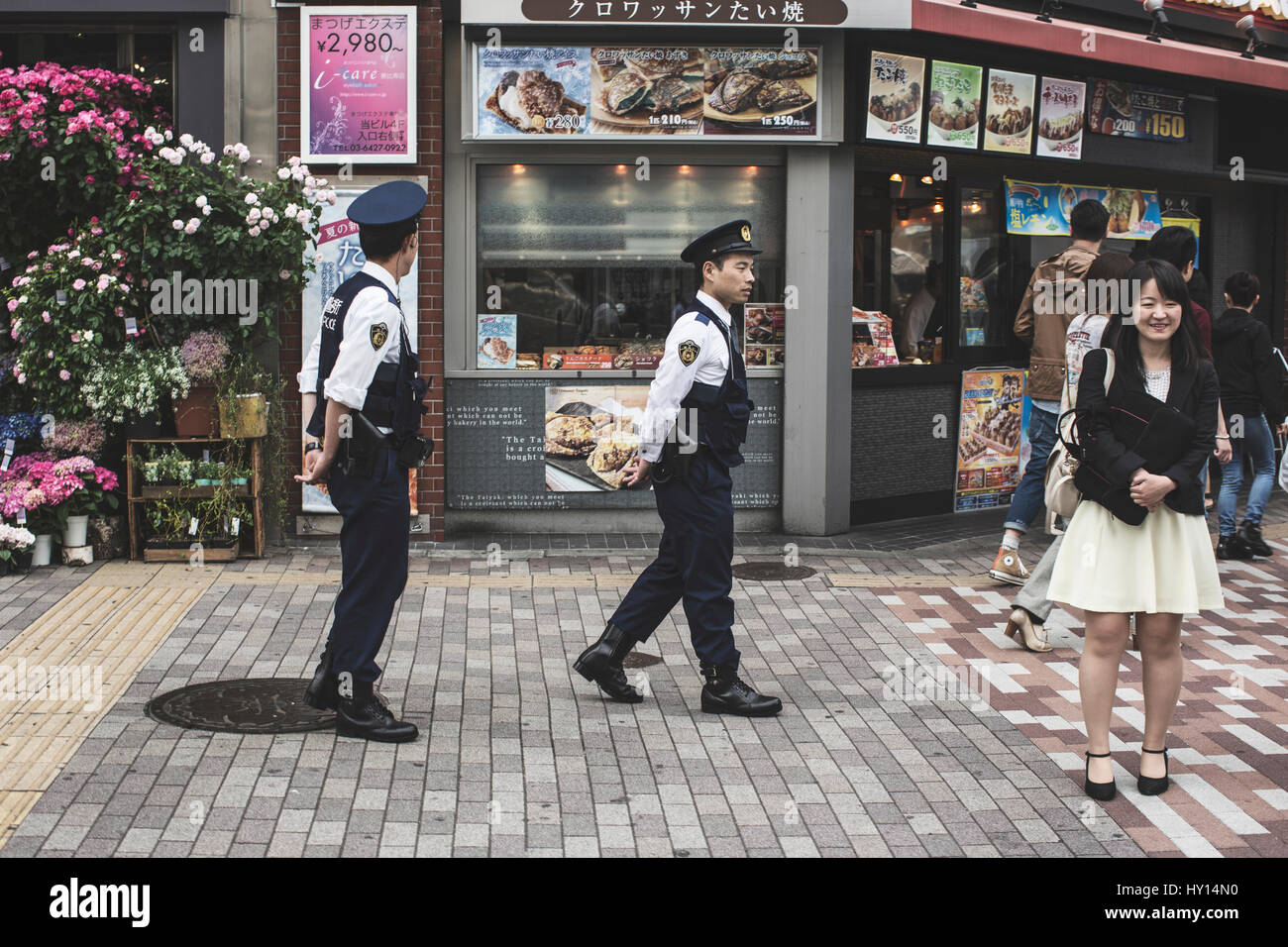 Two police officers on a street in Tokyo, Japan. Stock Photo