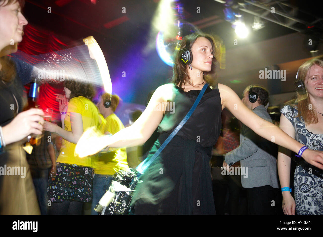 Woman in a black dress dancing at a silent disco, SWN festival, Cardiff ...