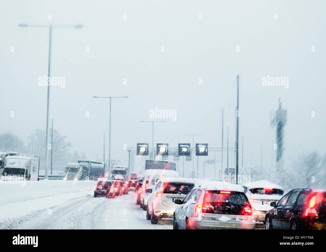 Sweden, Snowy street with car traffic on foggy day Stock Photo
