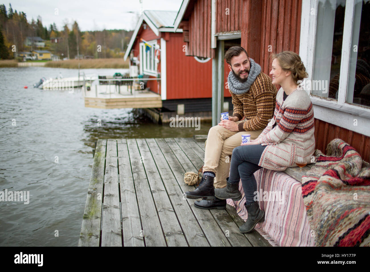 Sweden, Young couple sitting on bench Stock Photo