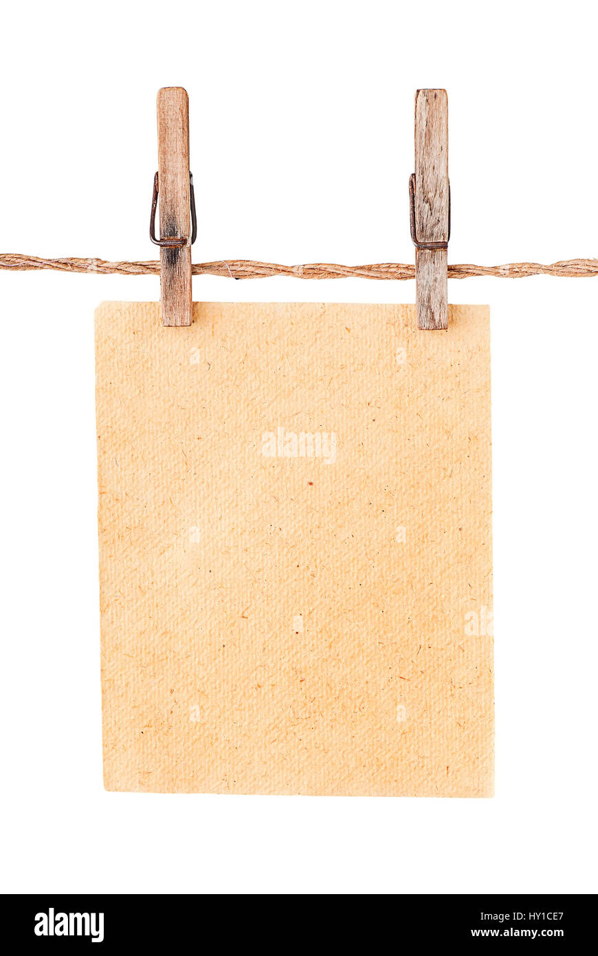 Piece old sheet of paper on two clothespins isolated on white background Stock Photo