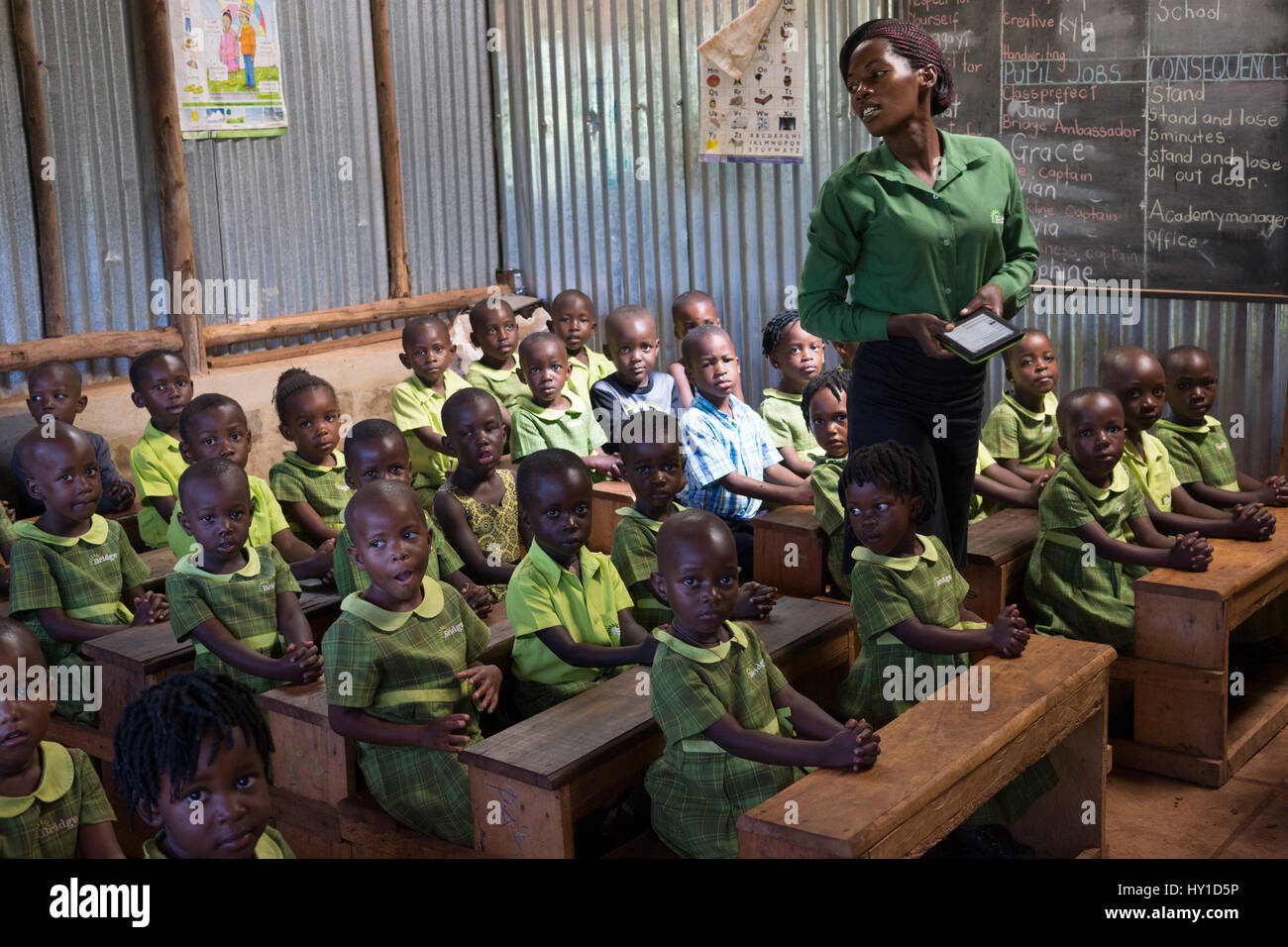 A teacher and her pupils at a Bridge International Academies primary school in Mpigi, Uganda. Stock Photo
