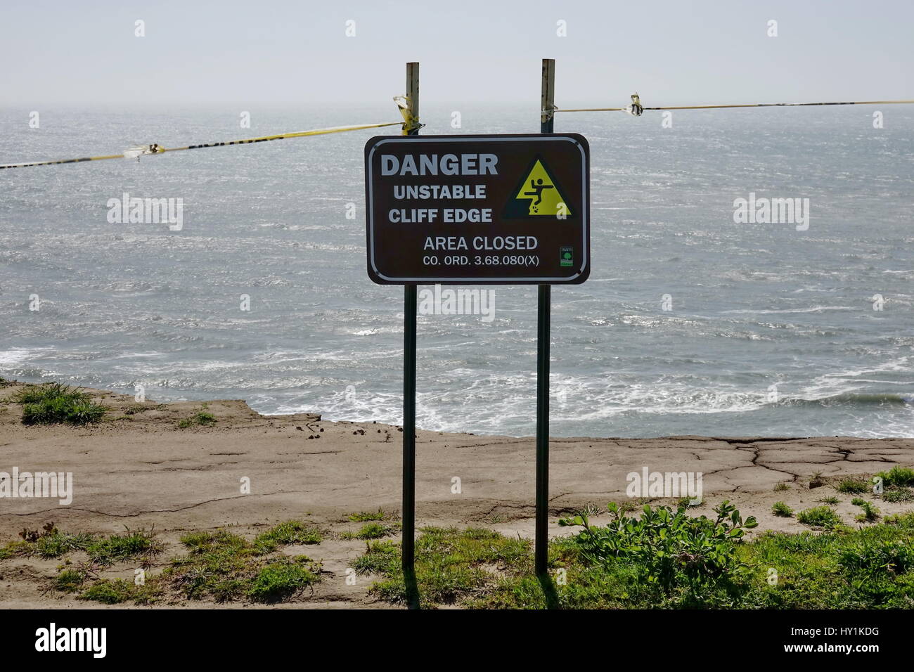 Sign Warns Hikers of Surf-Eroded Cliff on California Coastal Trail Stock Photo
