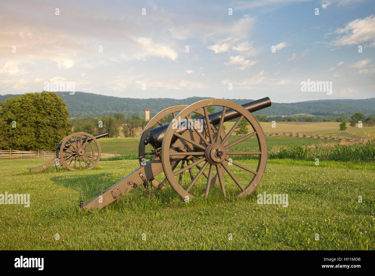 Cannon at Antietam (Sharpsburg) Battlefield in Maryland with the fence of Bloody Lane, also known as the Sunken Road in the middleground on the right. Stock Photo