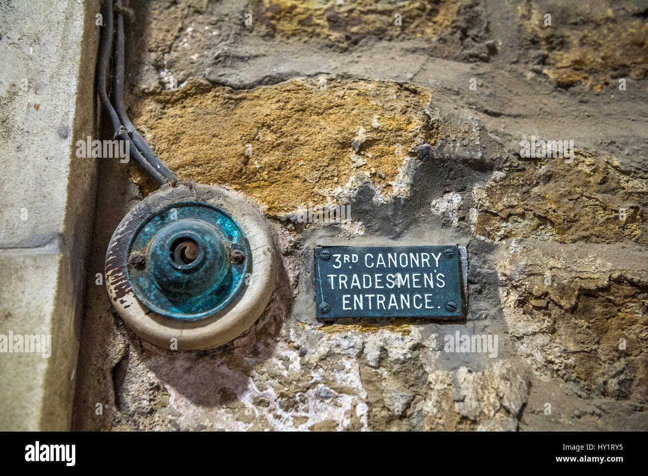 Old door bell push button for the tradesman entrance to Durham Cathedral and Canonry. Stock Photo