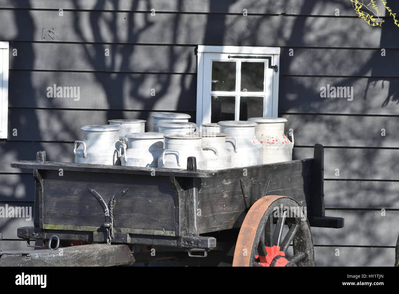 dairy canisters on wheeled wagon Stock Photo