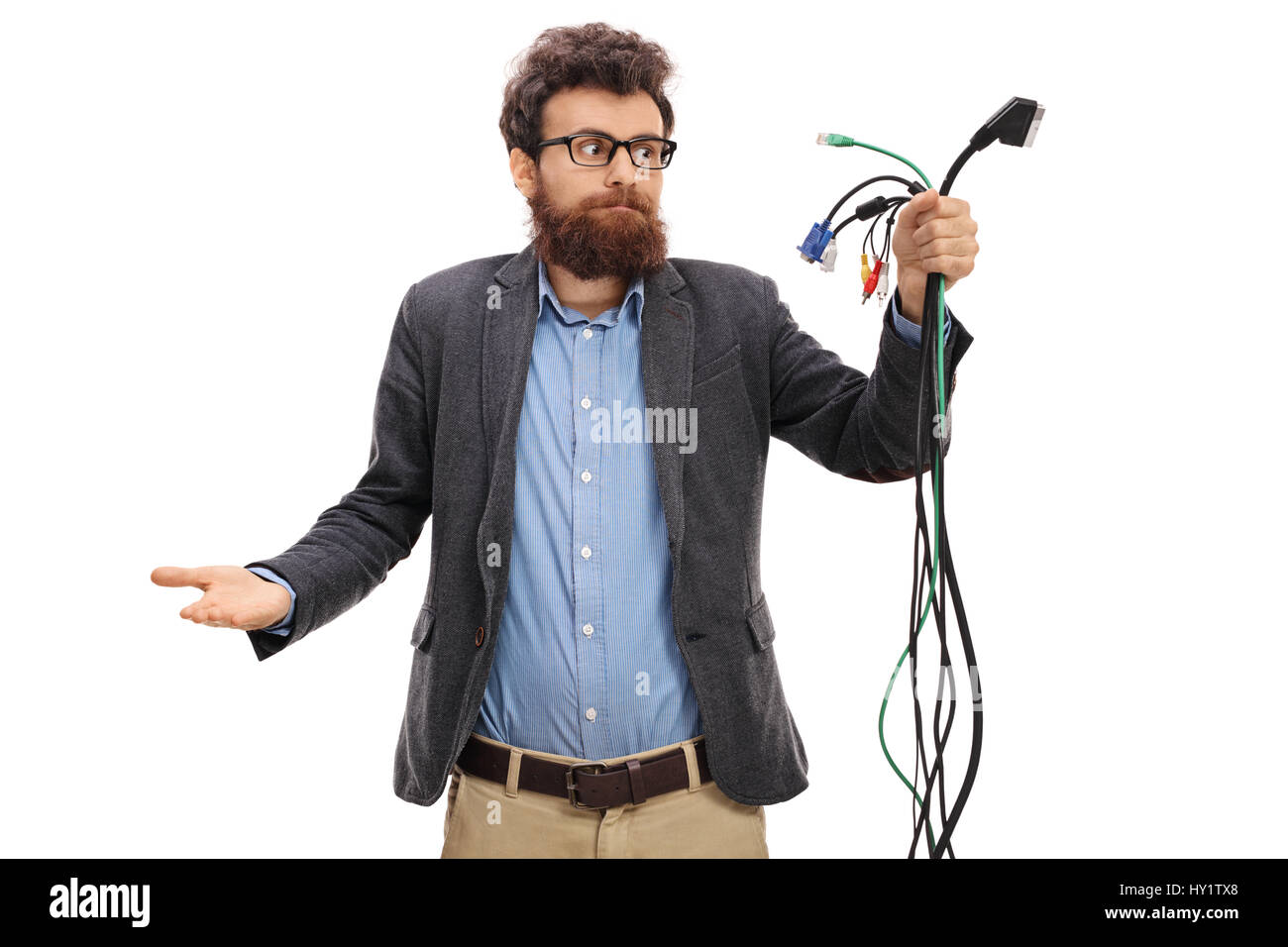 Confused guy looking at different types of electronic cables isolated on white background Stock Photo