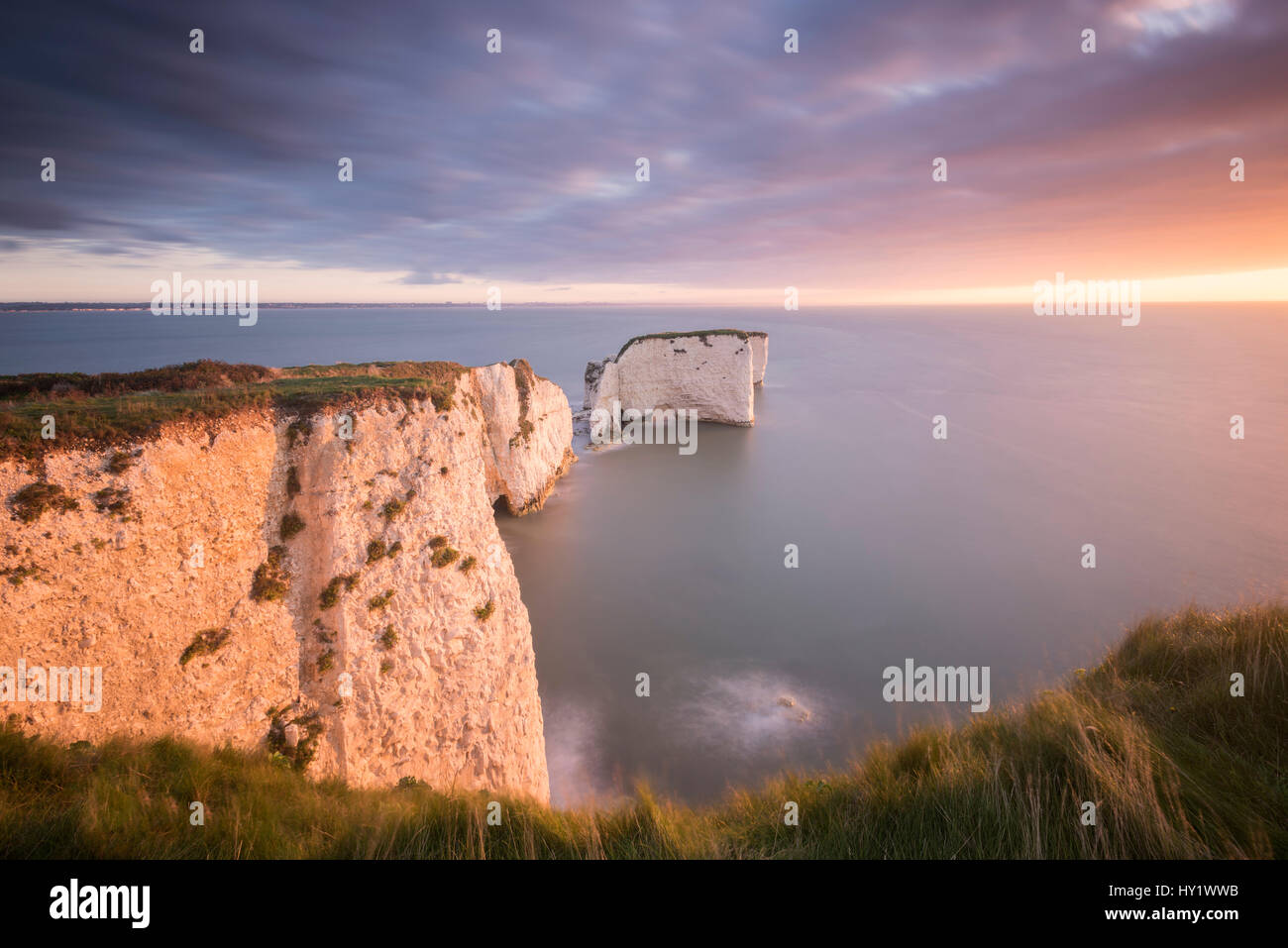 Old Harry Rocks, colourful sunrise looking towards the Isle of Wight, Studland, Dorset, UK. September . Stock Photo