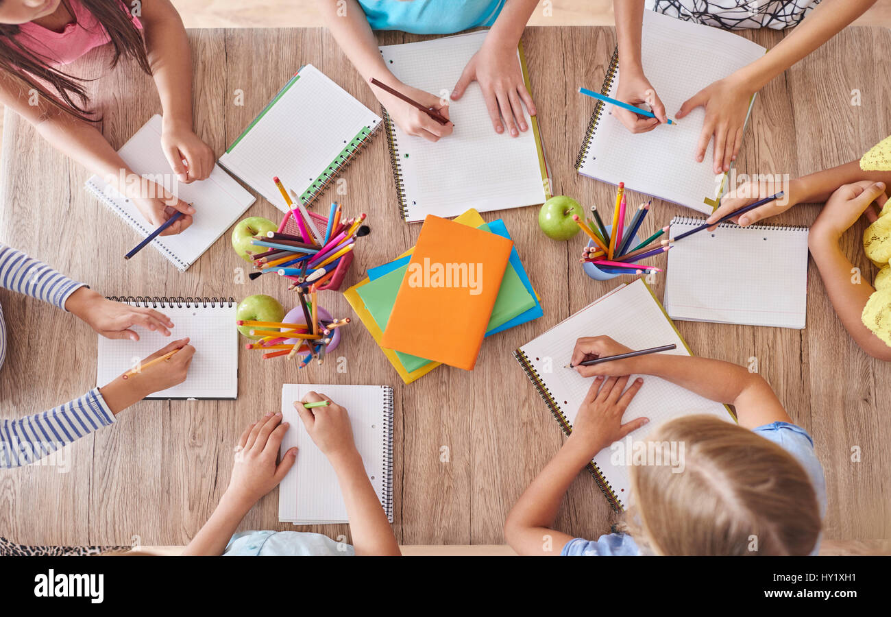 Kids around the school table Stock Photo Alamy