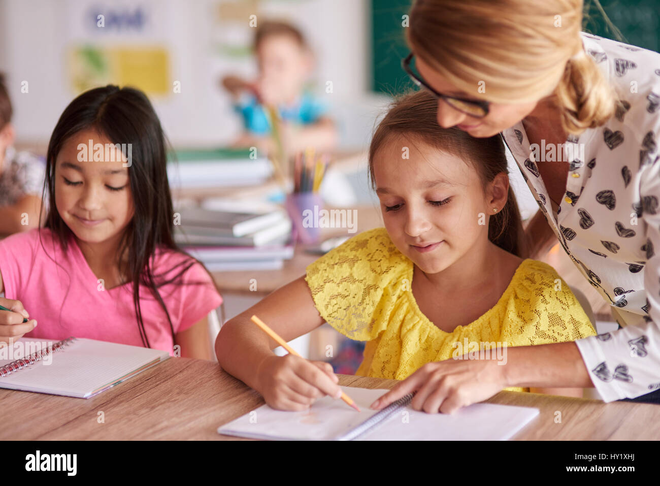 Teacher helping children hi-res stock photography and images - Alamy
