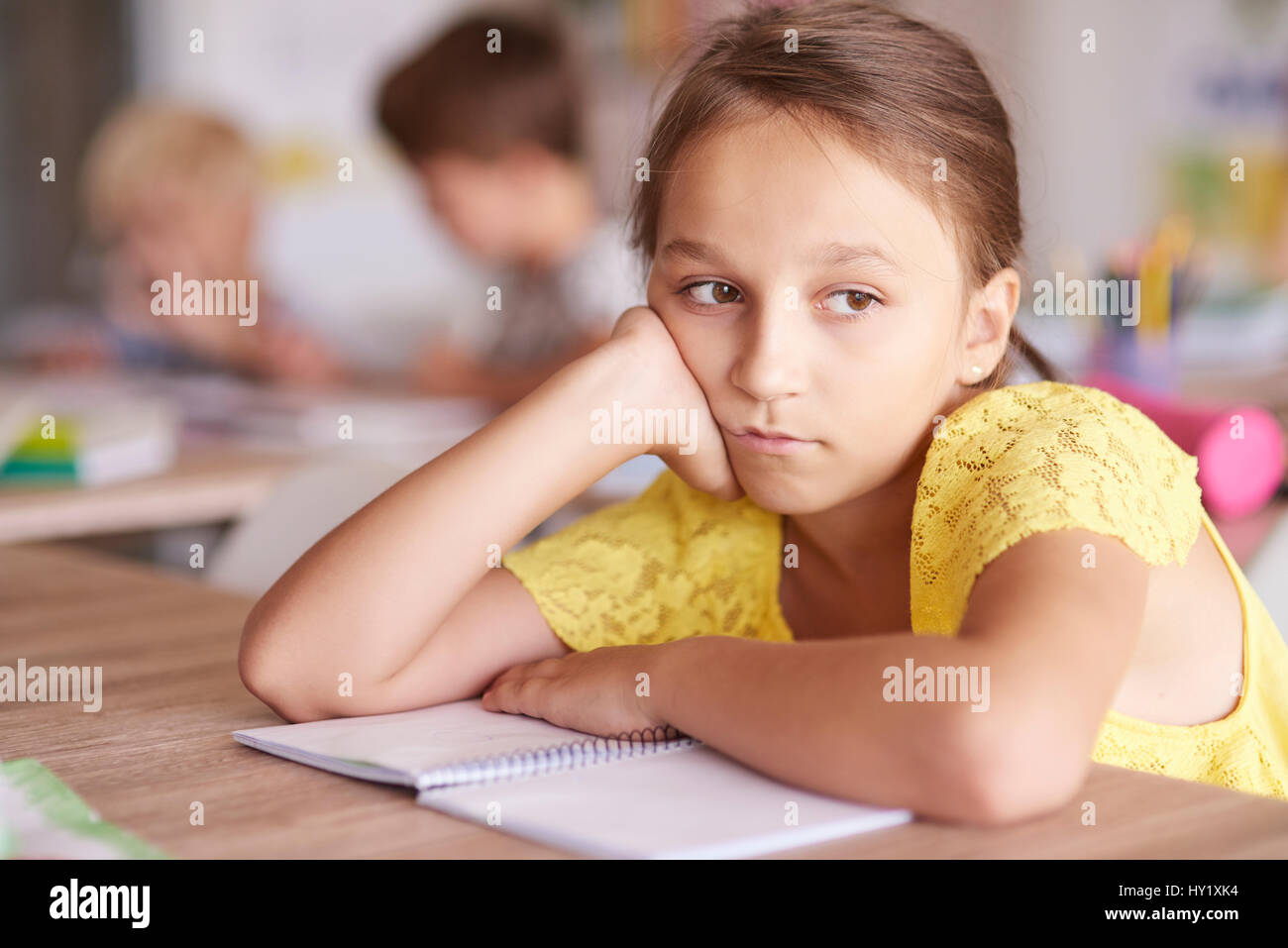 Girl bored at the lesson Stock Photo