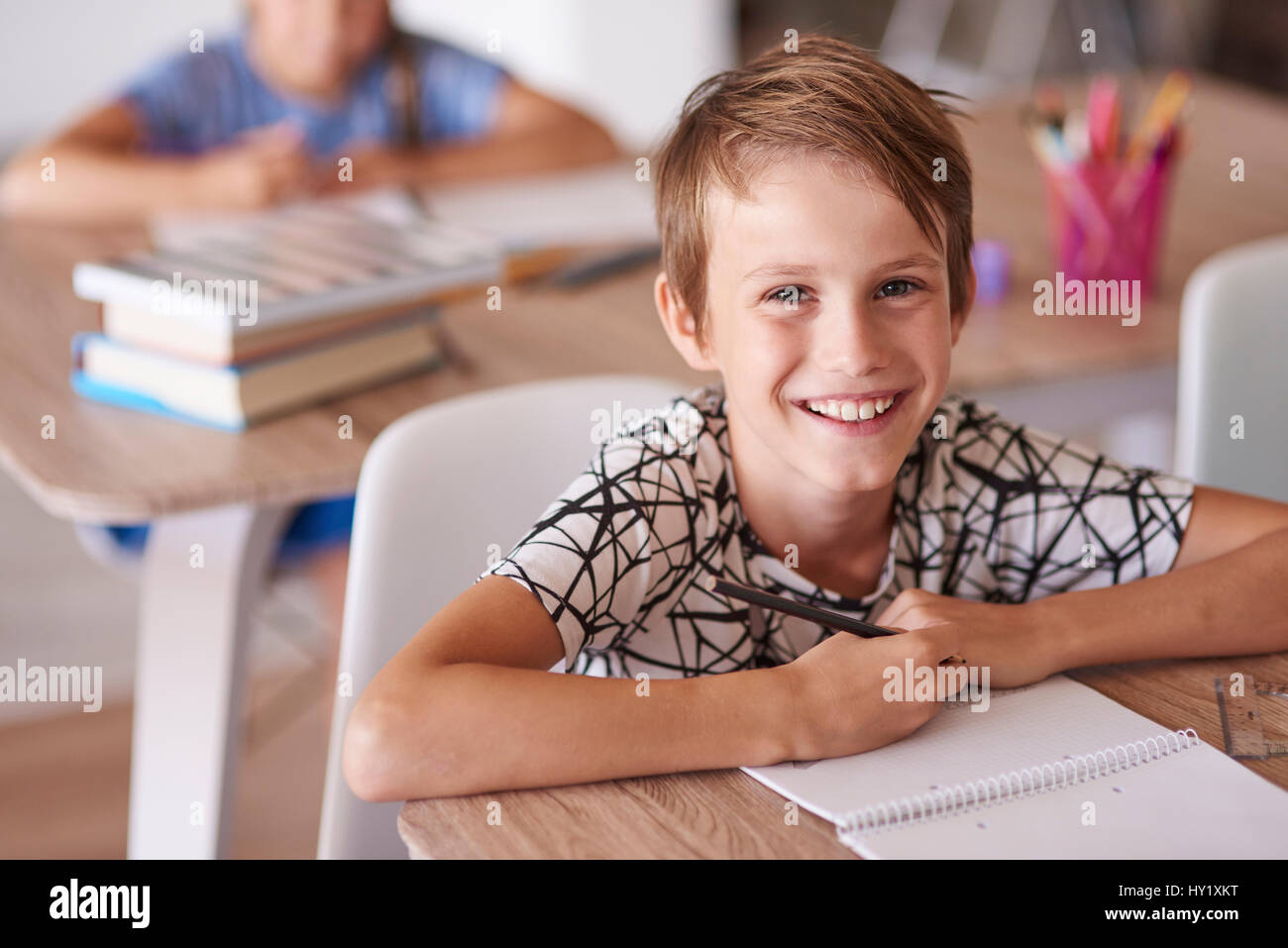 Cheerful boy in the school desk Stock Photo