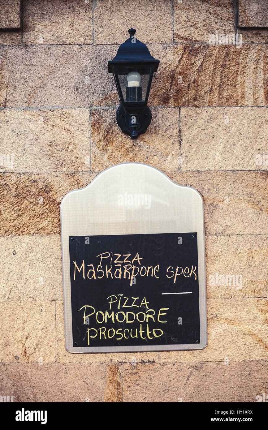 Commercial panel on the wall with written text that says that pizza is on the menu. Stock Photo