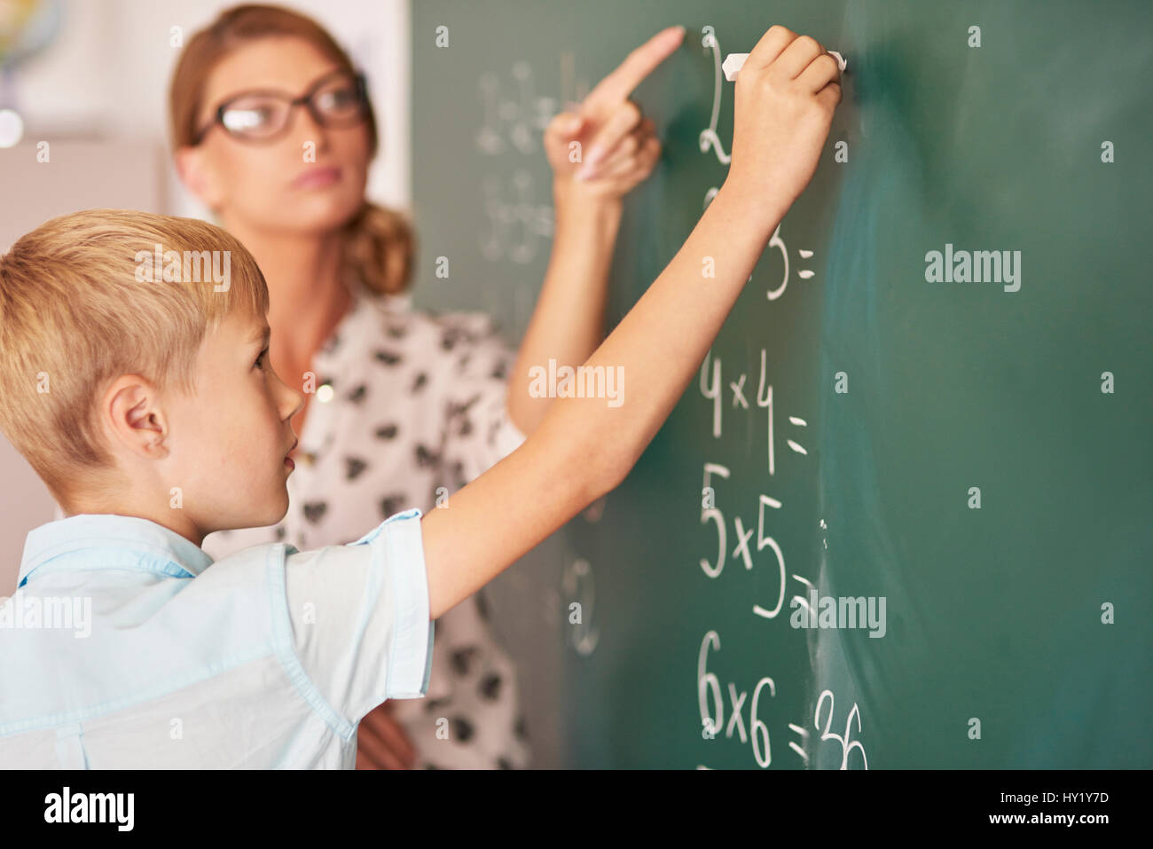 Teacher trying to help boy understand the Maths Stock Photo