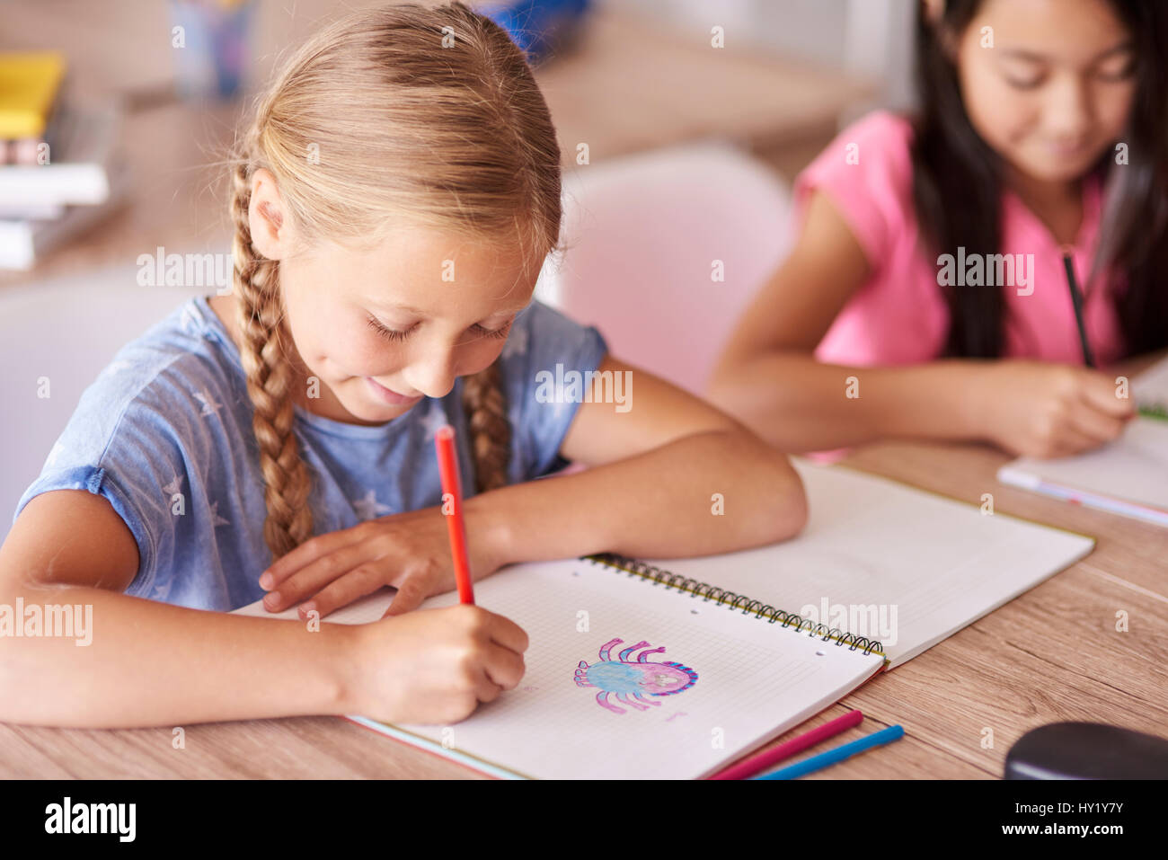 Student girl drawing during lesson Stock Photo