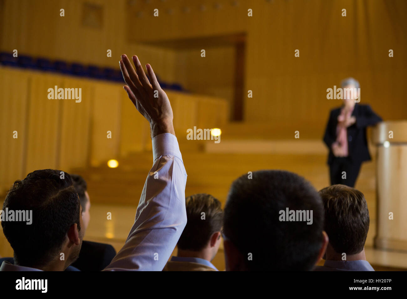 Business executives actively participating in conference center Stock Photo
