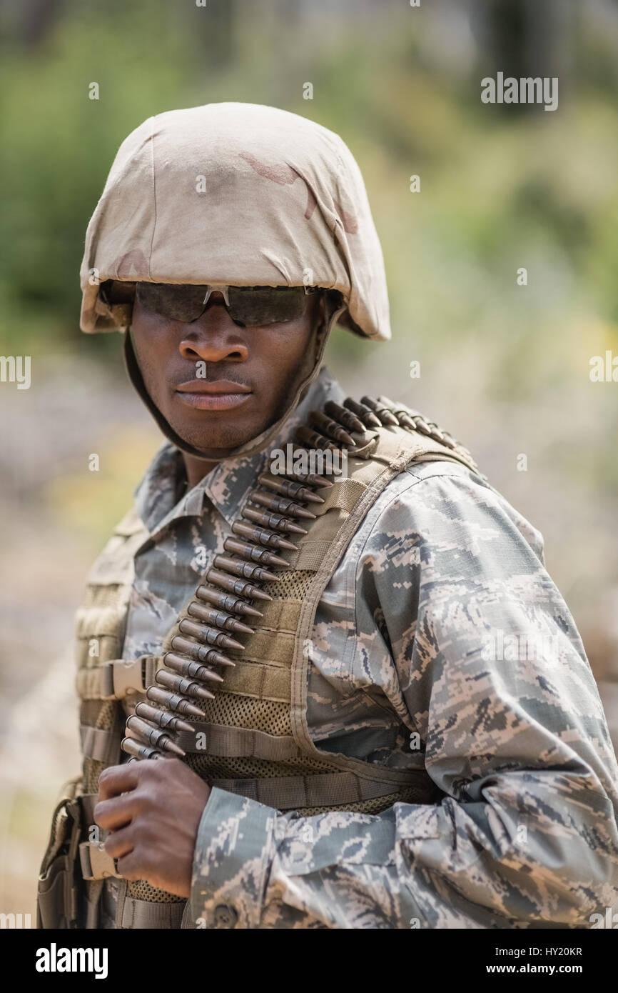 Military soldier standing with ammunition in boot camp Stock Photo