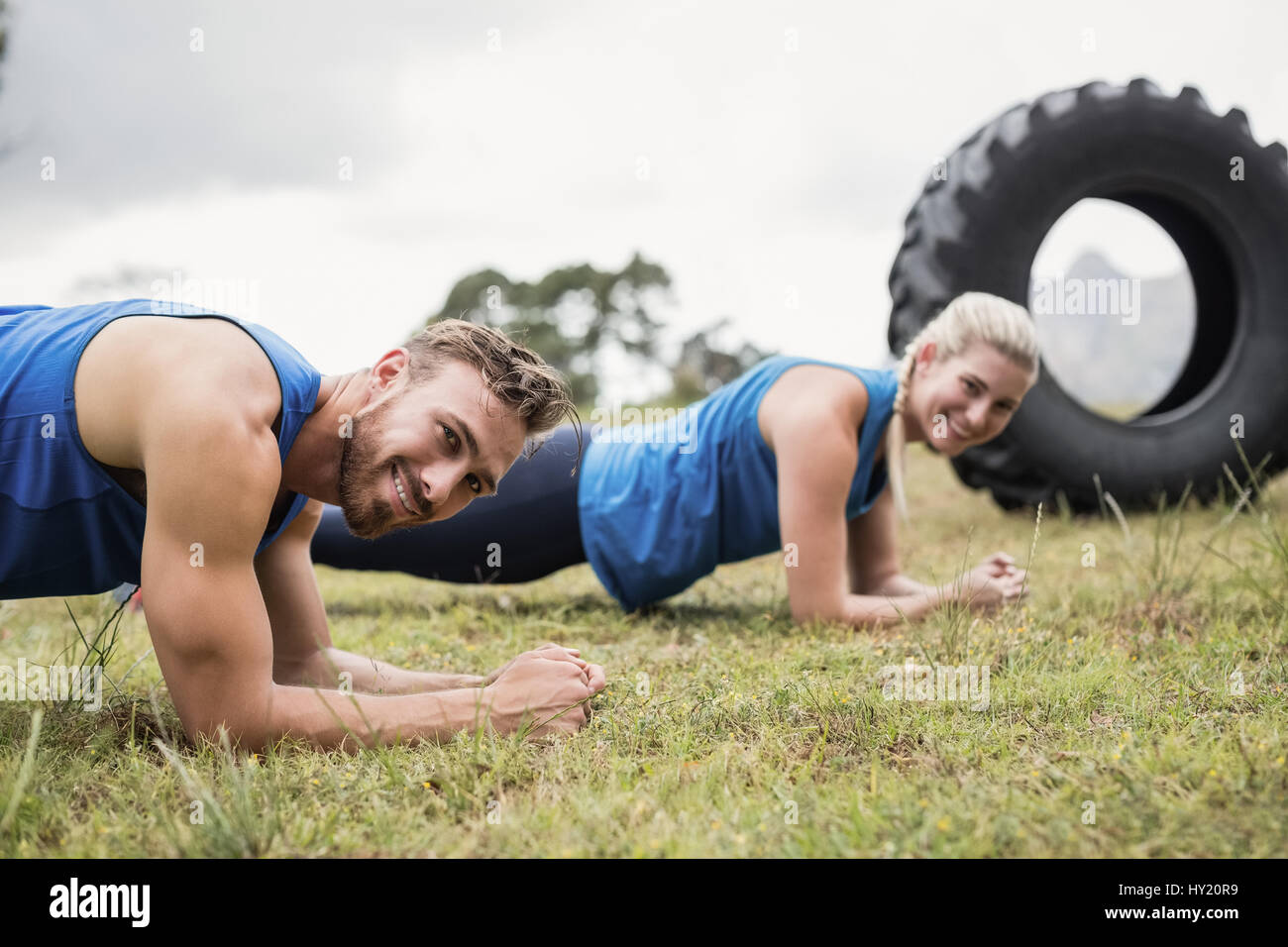 Fit people performing pushup exercise in boot camp Stock Photo