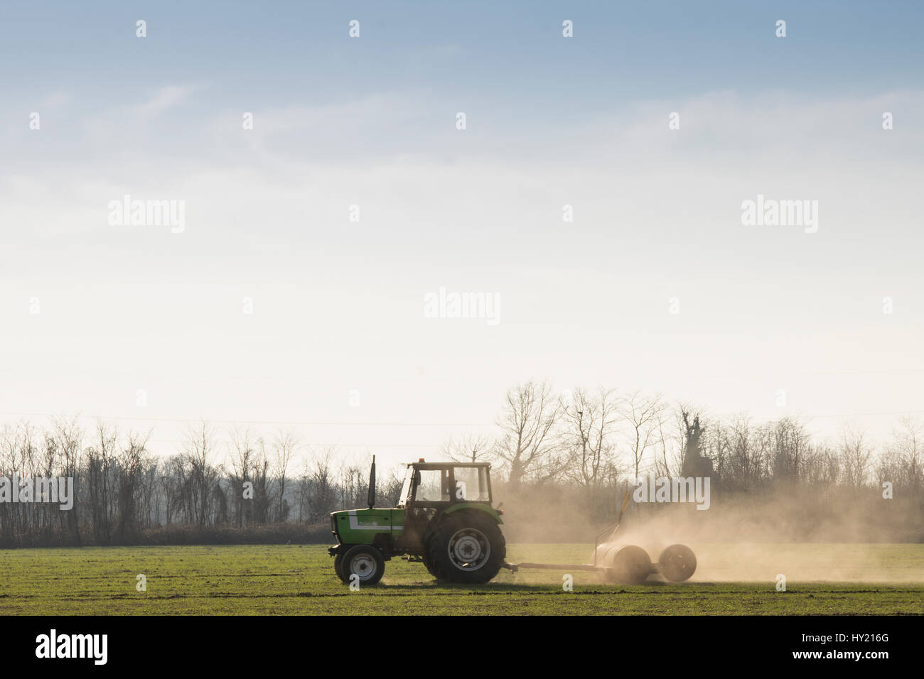 a tractor is plowing the soil Stock Photo
